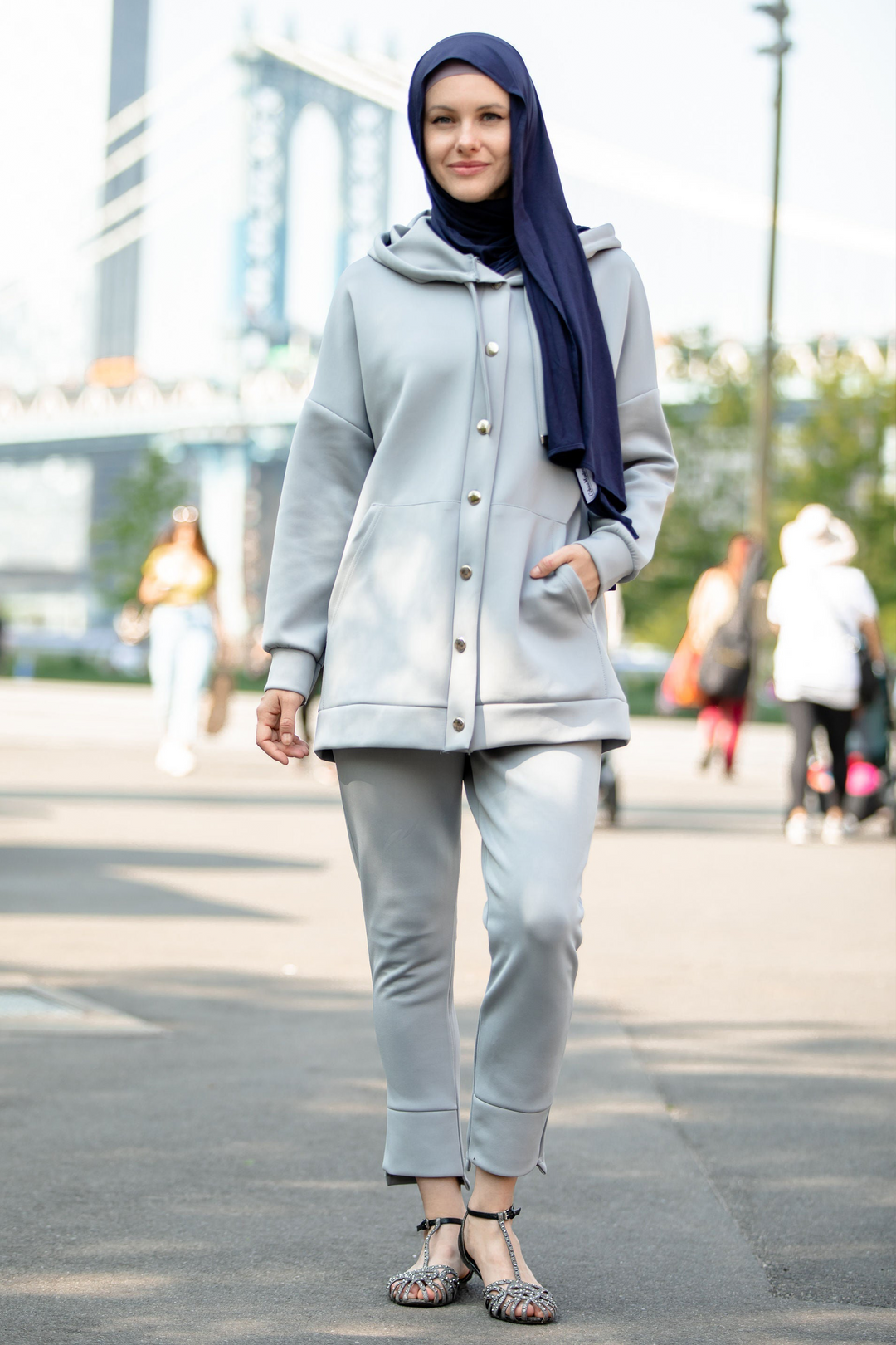 Woman wearing gray hoodie tracksuit and navy hijab in clearance sale