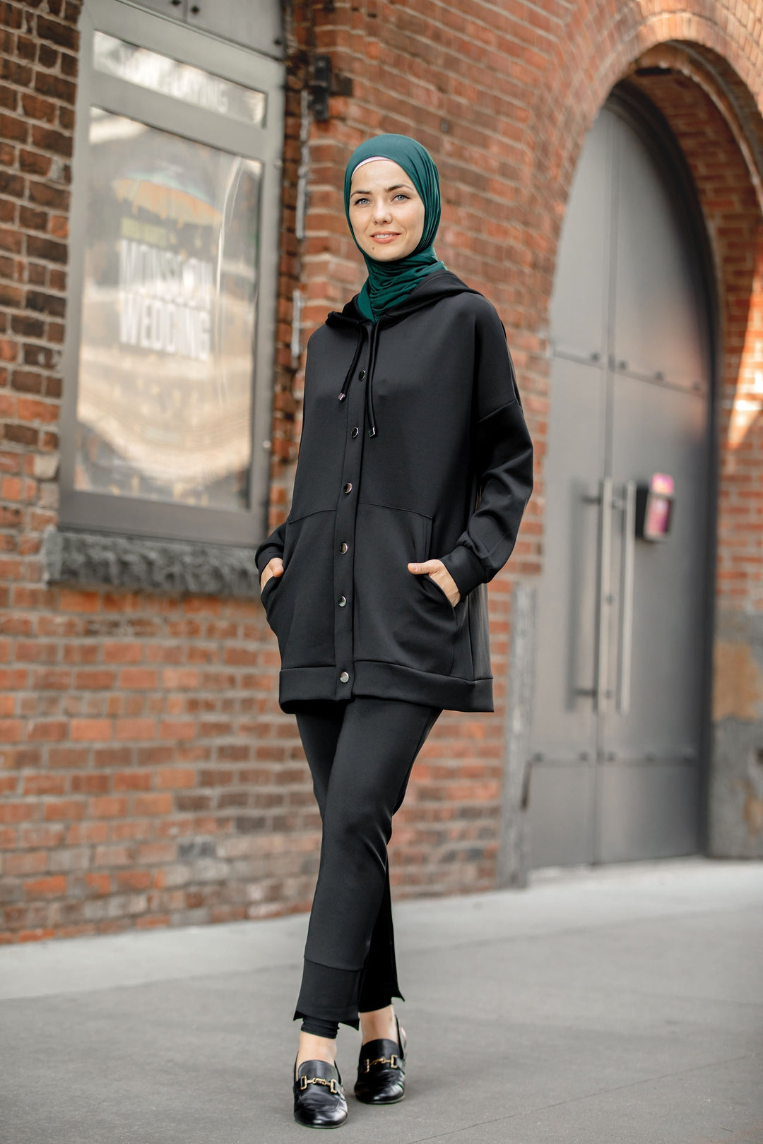 Woman in black modest sportswear showcasing Button Down Hoodie Sweatshirt and Pants Set