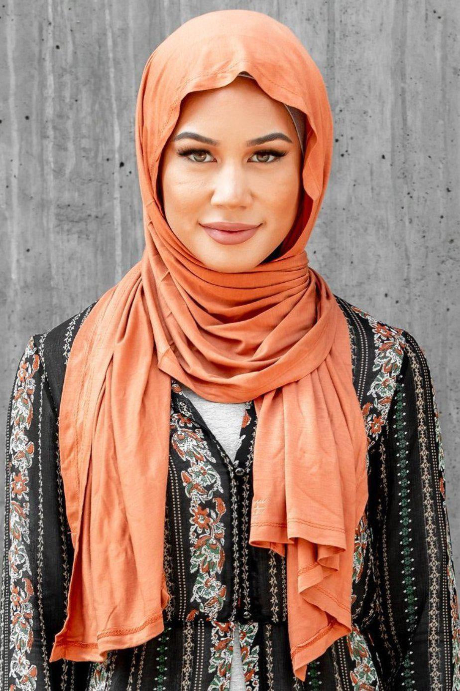 Woman in orange Camel Jersey Hijab showcasing elegant and versatile style