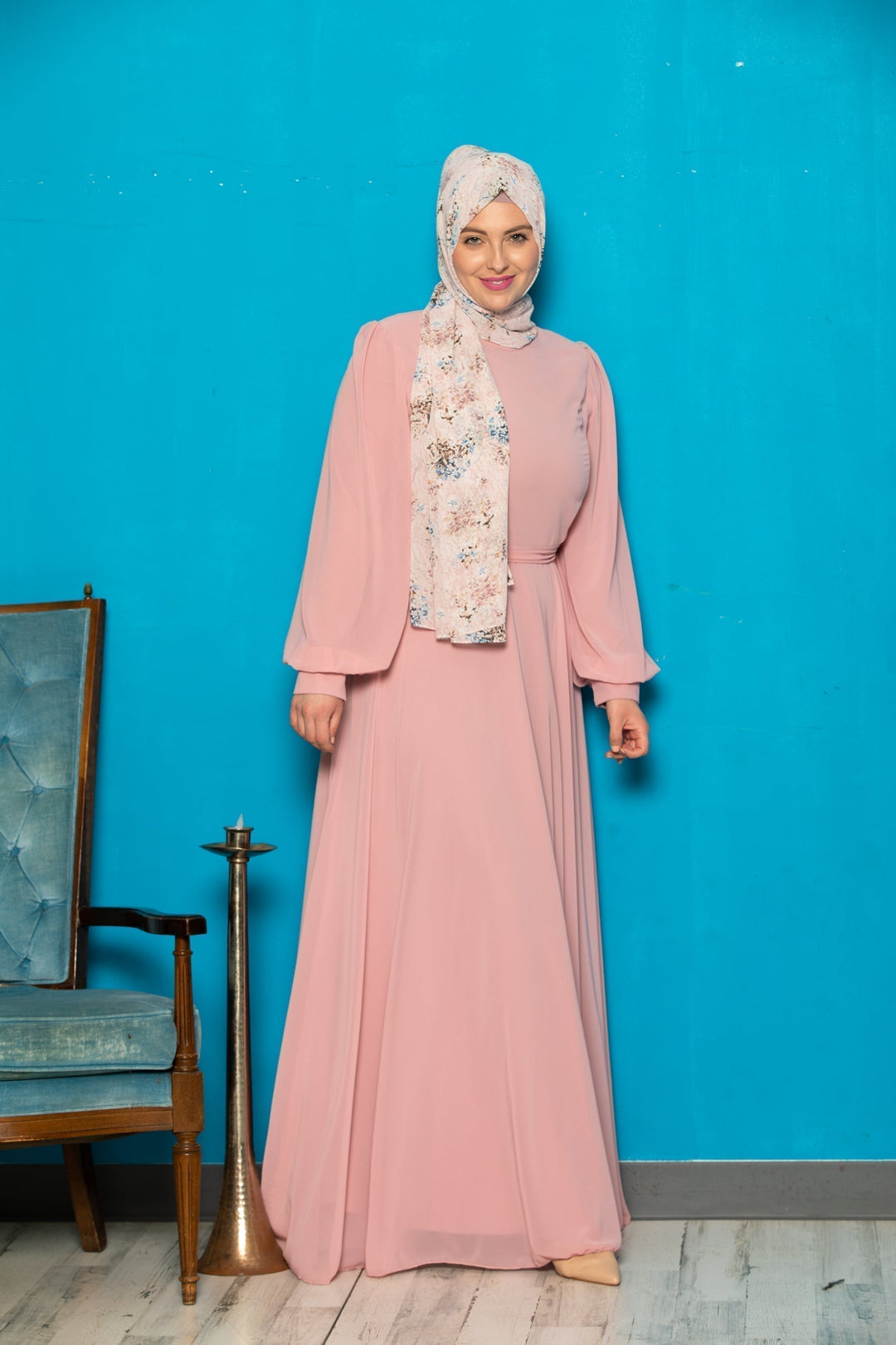 Woman in a pink chiffon long sleeve gown with floral hijab and belt included