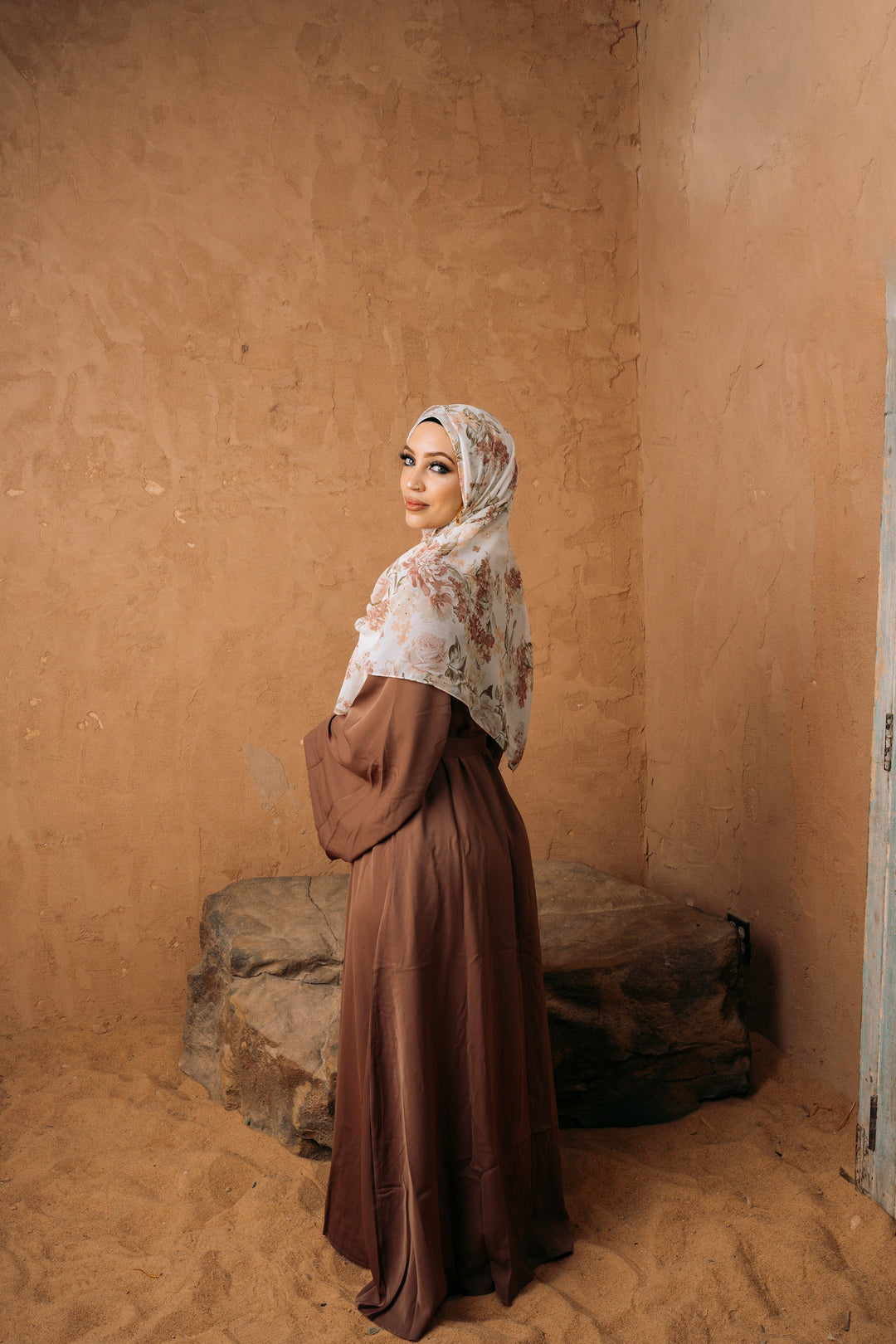 Woman in brown kimono sleeve abaya maxi dress with floral hijab and fabric tie belt