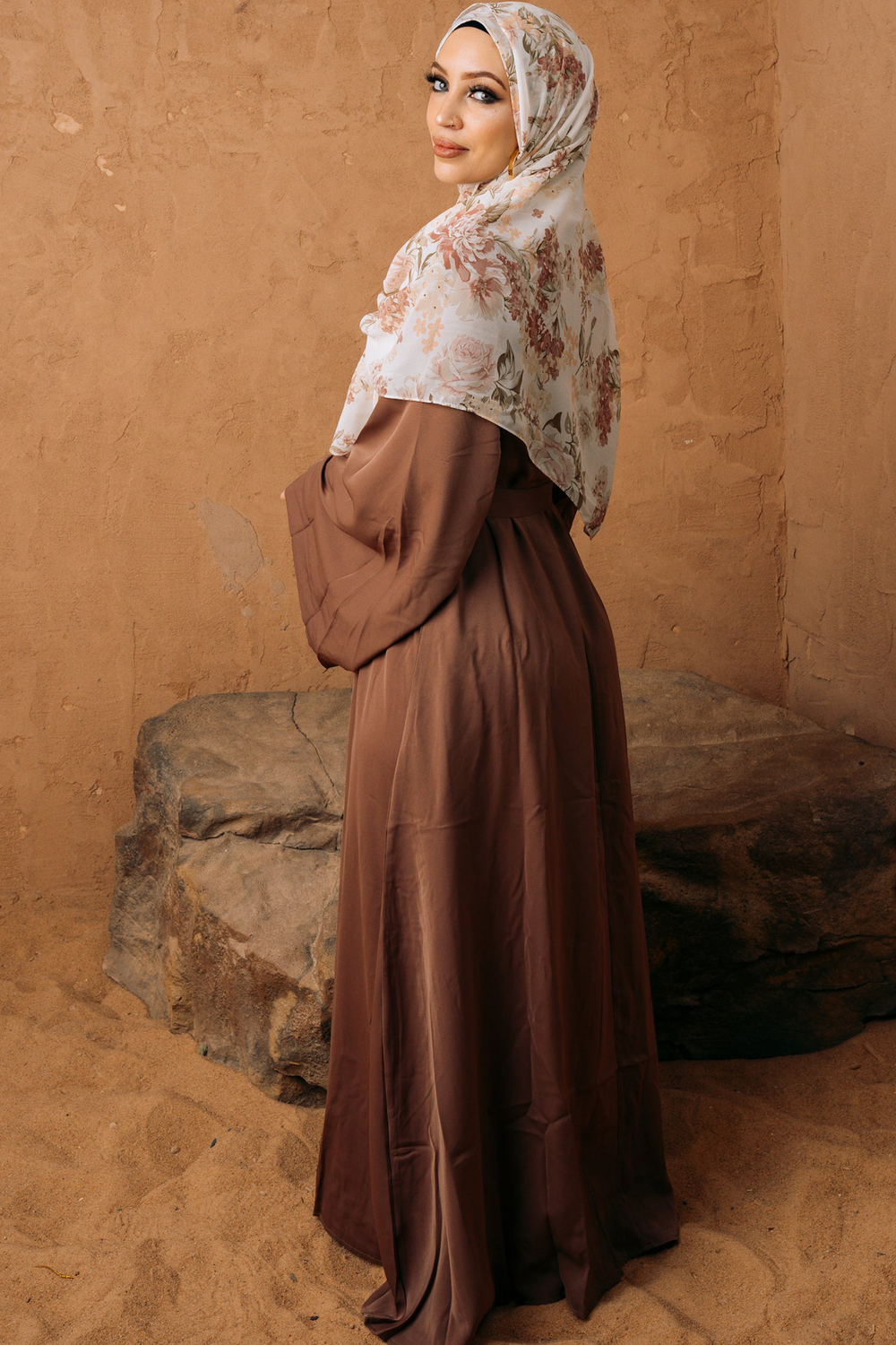 Woman in brown kimono sleeve abaya maxi dress with floral hijab and fabric tie belt