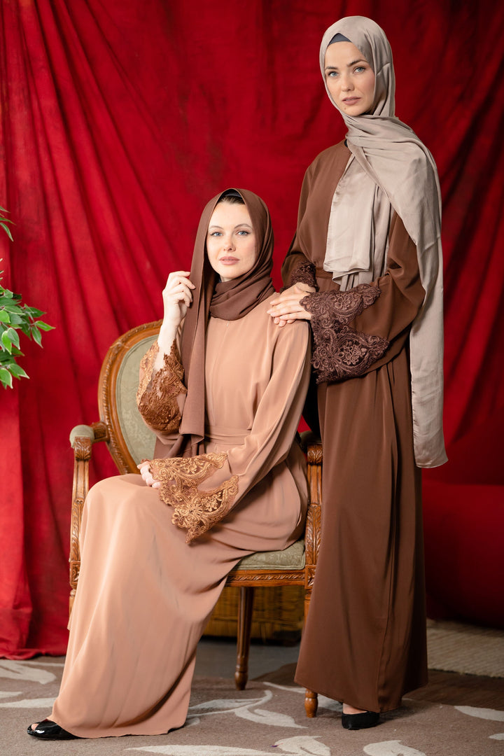 Two women showcase the Coffee Lace Sleeve Front Zipper Abaya Dress with fabric tie belts