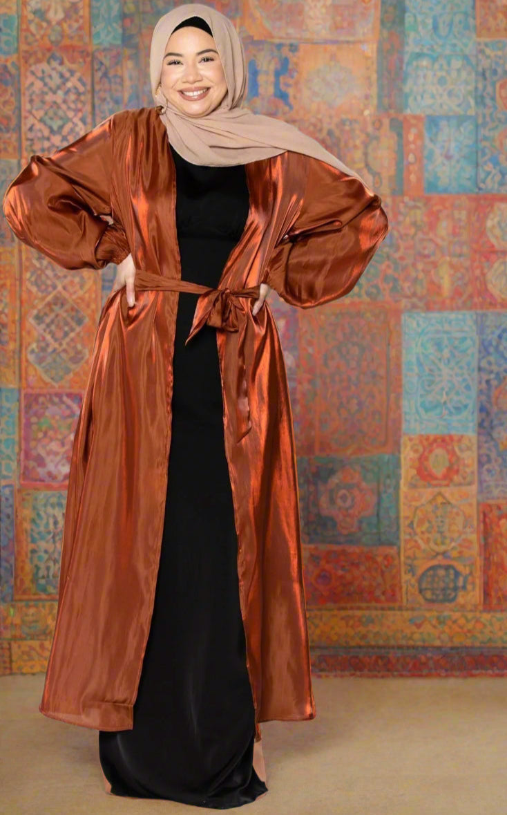 Woman in hijab wearing a shiny copper robe, showcasing Copper Organza Open Abaya