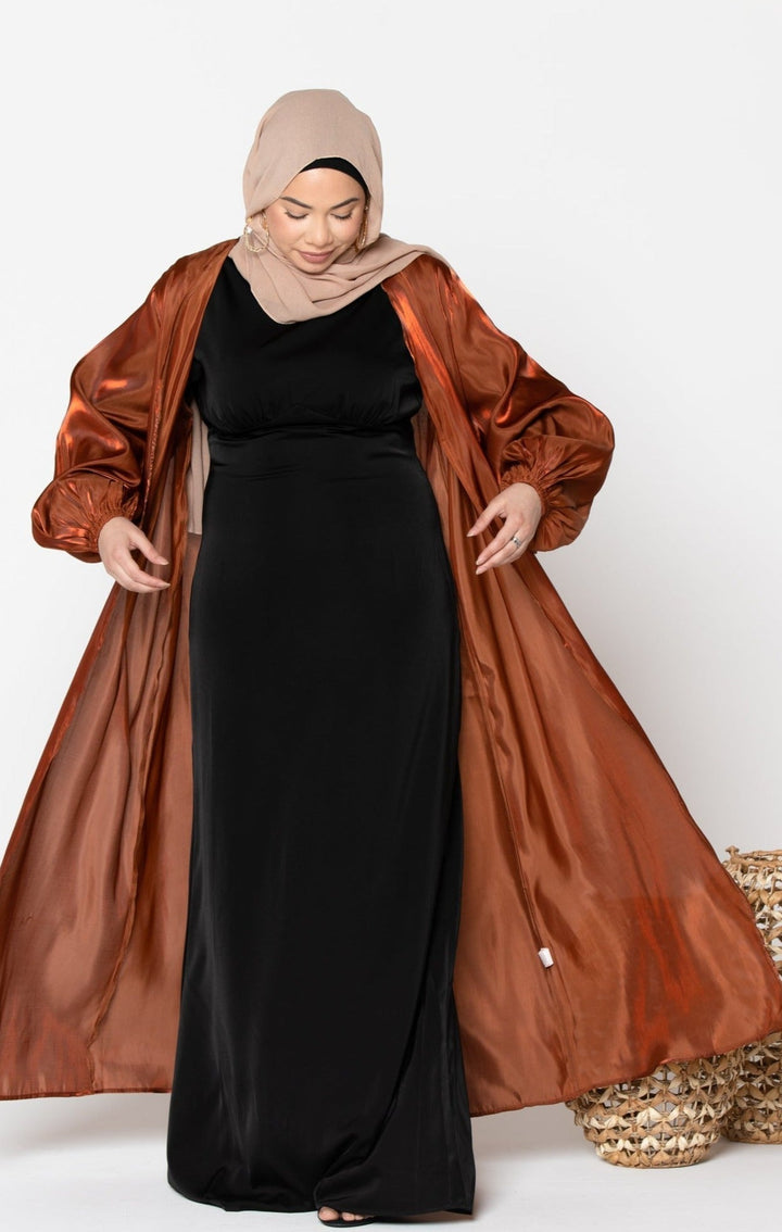 Woman in a black dress with a Copper Organza Open Abaya and elastic bands