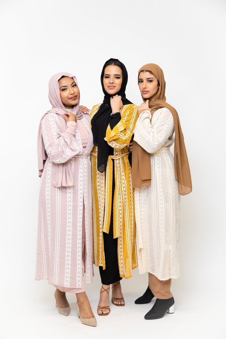 Three women showcase the Cream Boho Lace Embroidered Sheer Midi Cardigan in style