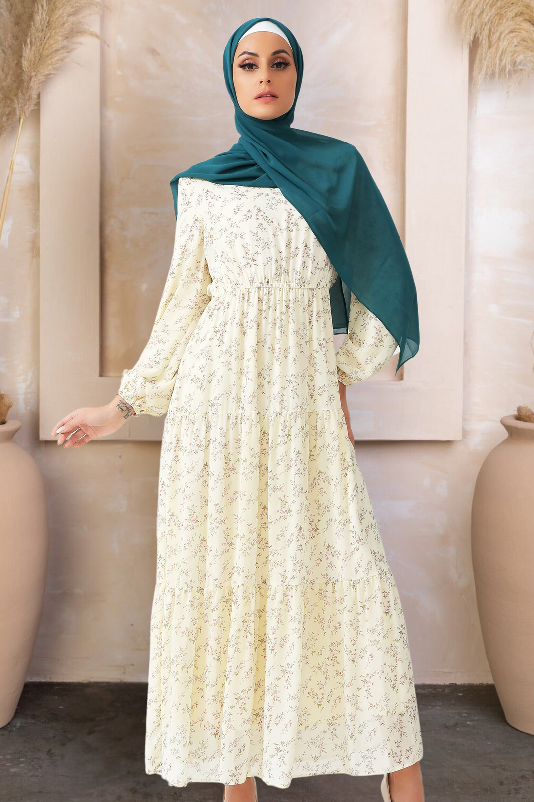 Woman in a floral tiered maxi dress and teal hijab showcasing Cream Floral Tiered style