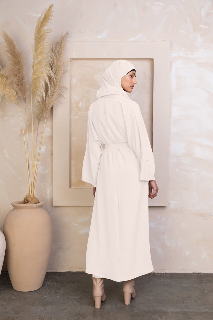 Woman in cream-colored dress and hijab showcasing Cream Four Piece Open Abaya Set