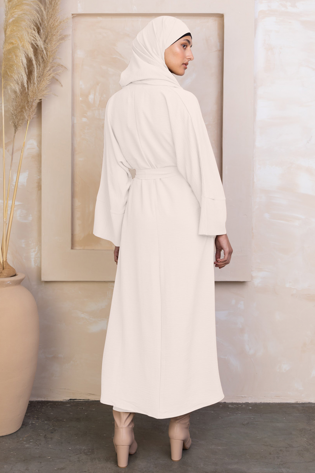 Woman in a long white dress and hijab modeling a Cream Four Piece Open Abaya Set