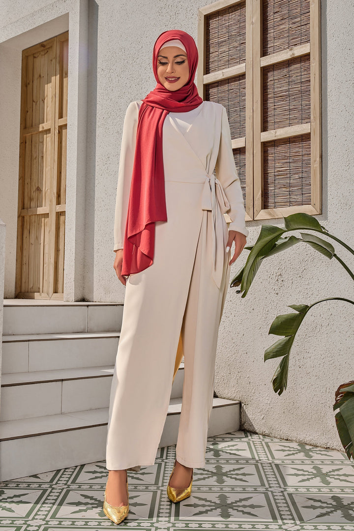 Woman in modest hijab wearing a Cream Side Knot Jumpsuit styled like a maxi dress