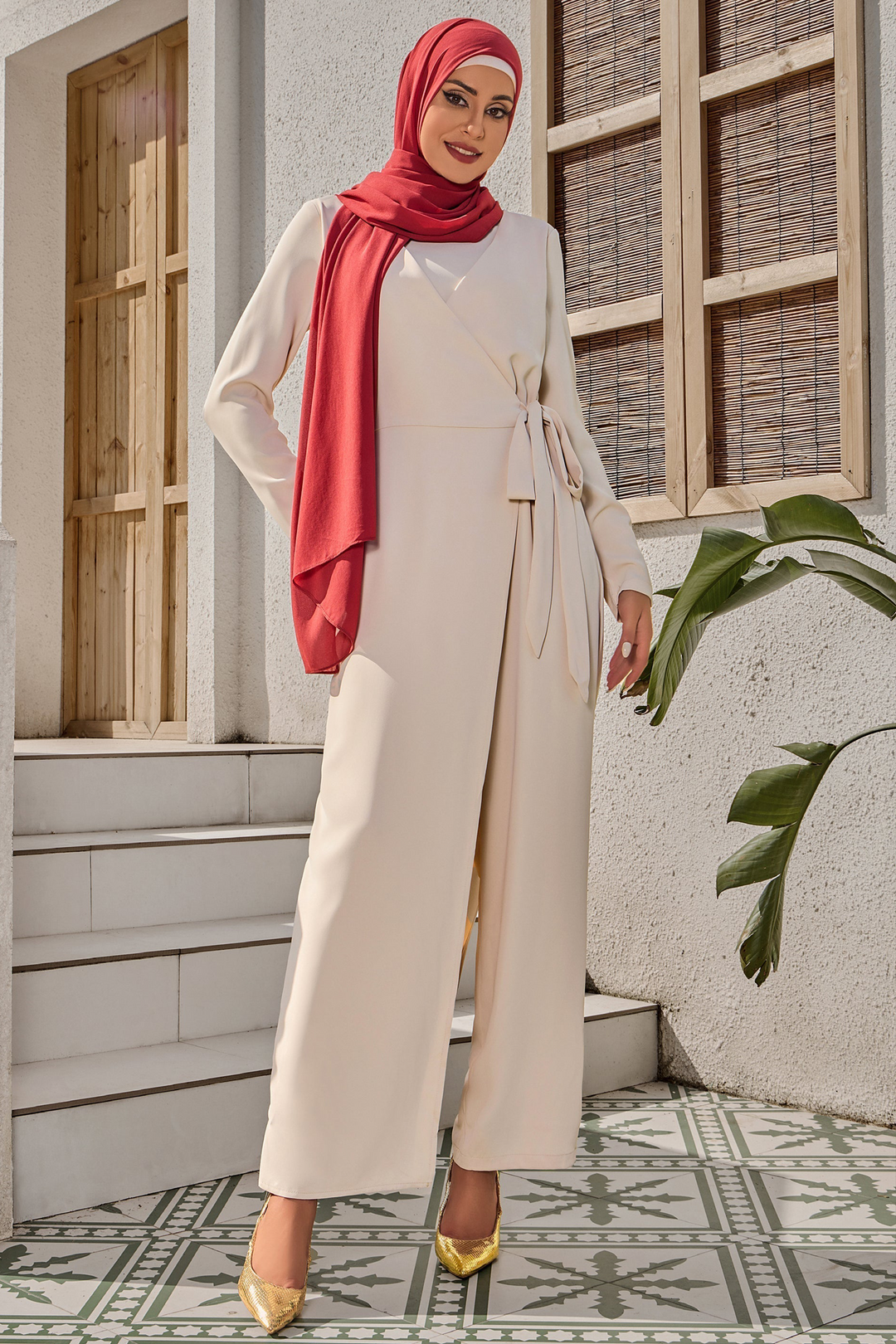 Woman in beige jumpsuit and red hijab showcasing Cream Side Knot Jumpsuit