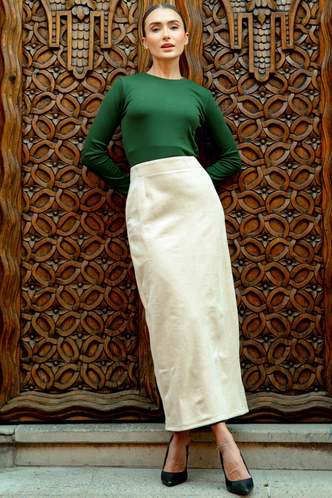 Woman wearing a green top with a cream suede pencil maxi skirt on clearance