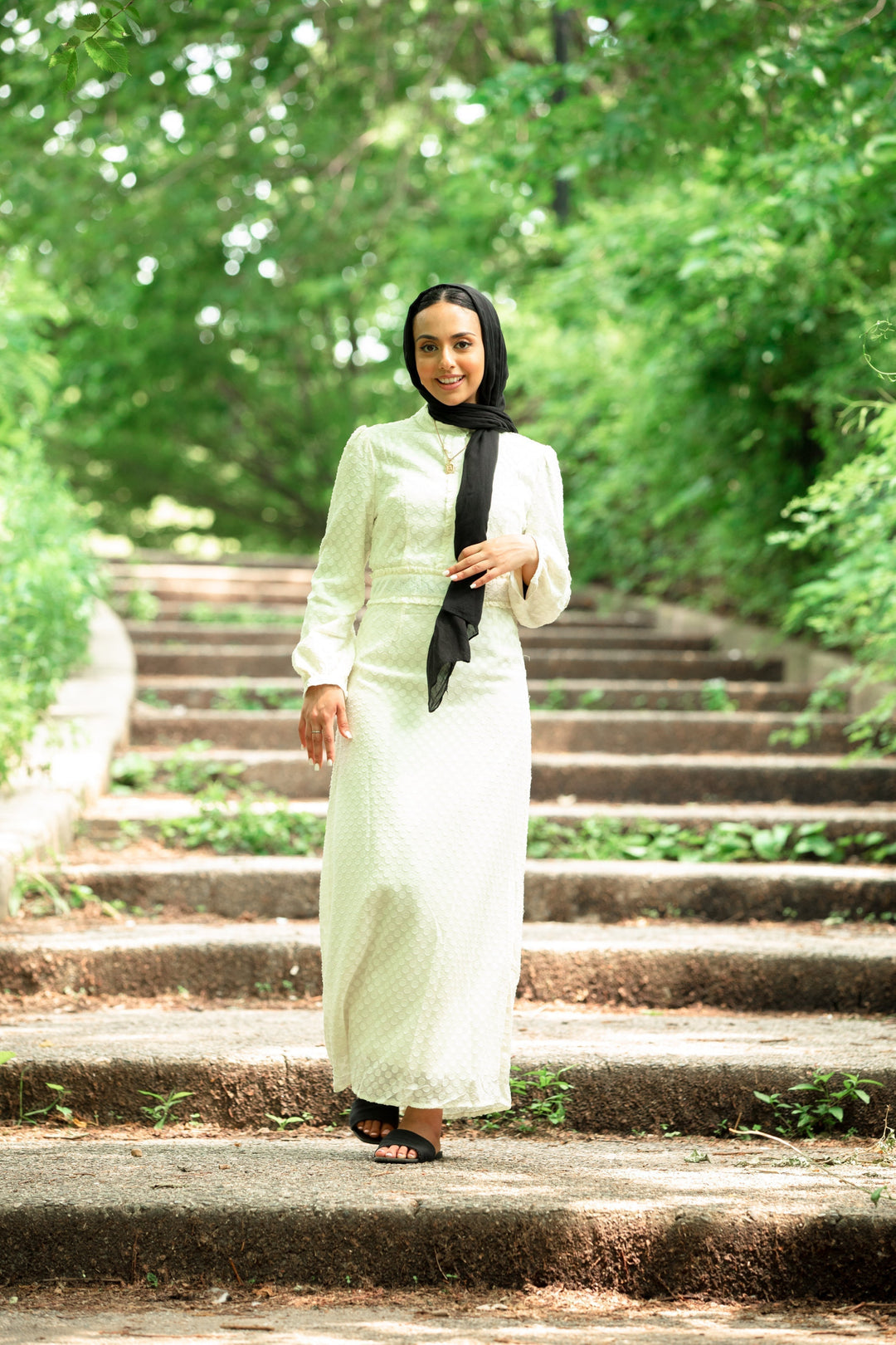 Woman in black hijab wearing cream textured polka dots long sleeve maxi dress