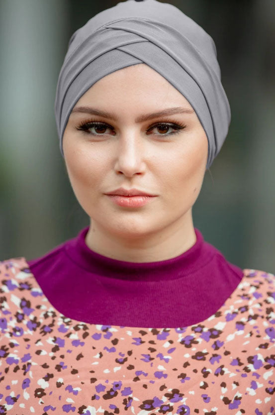 Woman wearing a gray tube hijab underscarf in Criss-Cross style, various colors available