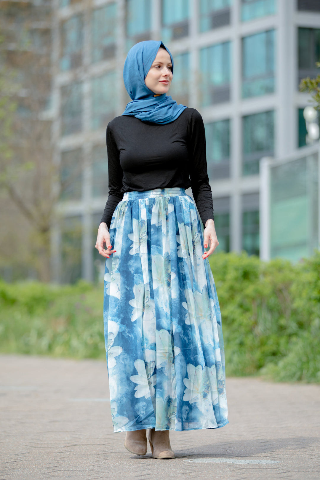 Woman in a blue hijab wearing the Day Dreams Floral Maxi Skirt on clearance