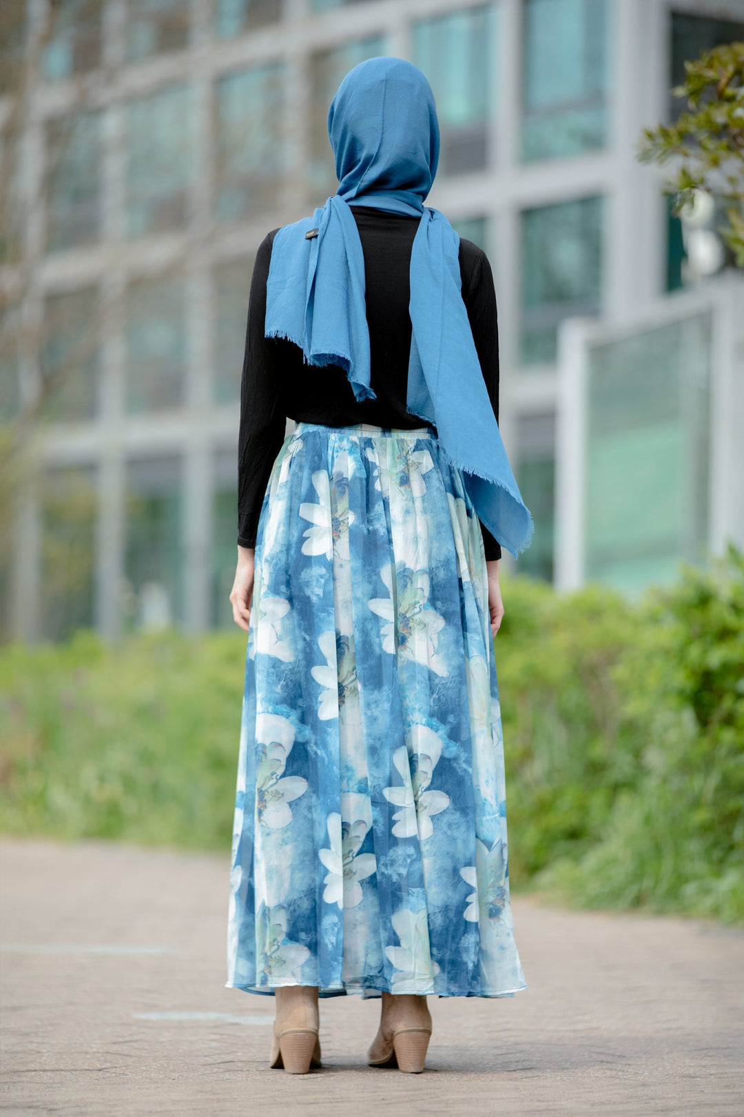 Woman wearing Day Dreams Floral Maxi Skirt with a hijab and vibrant floral patterns