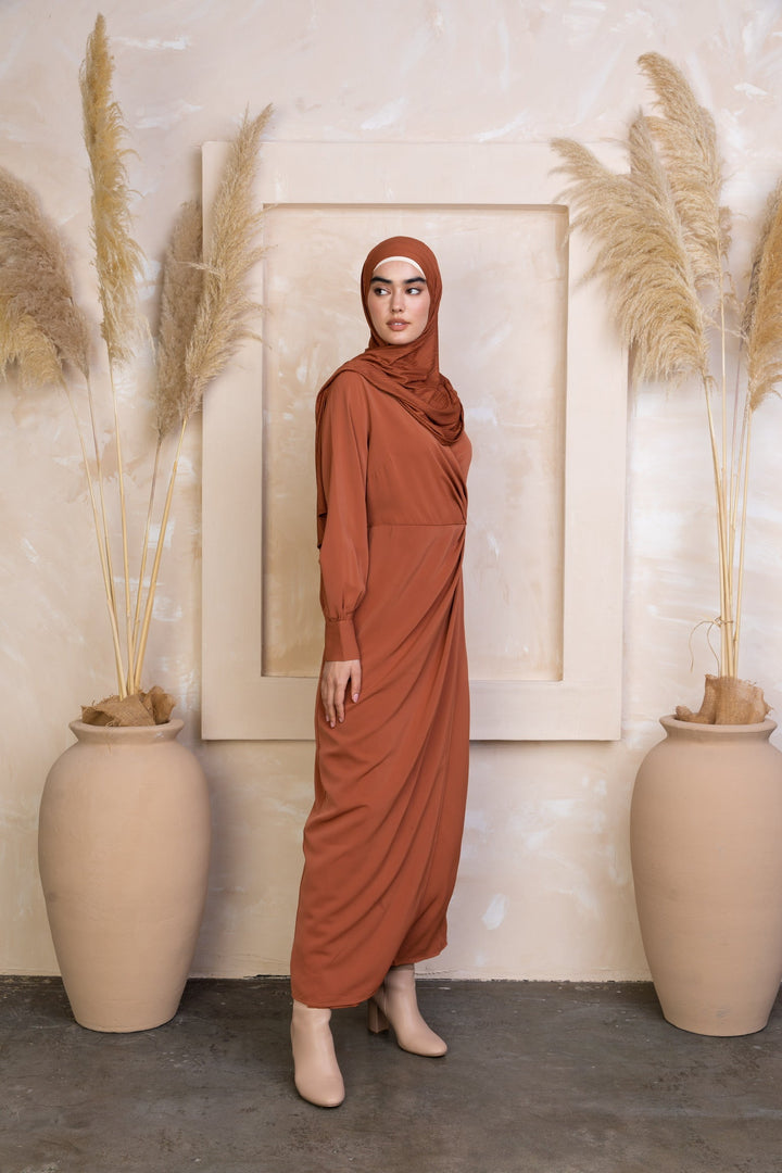 Rust-colored Deep Cider Wrap Maxi Dress featuring a criss cross neckline and hijab