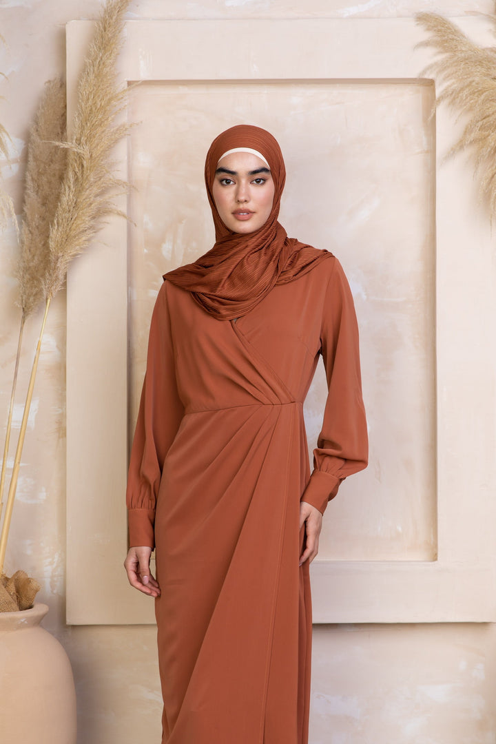 Woman in a brown Deep Cider Wrap Maxi Dress with criss cross neckline and wrap skirt