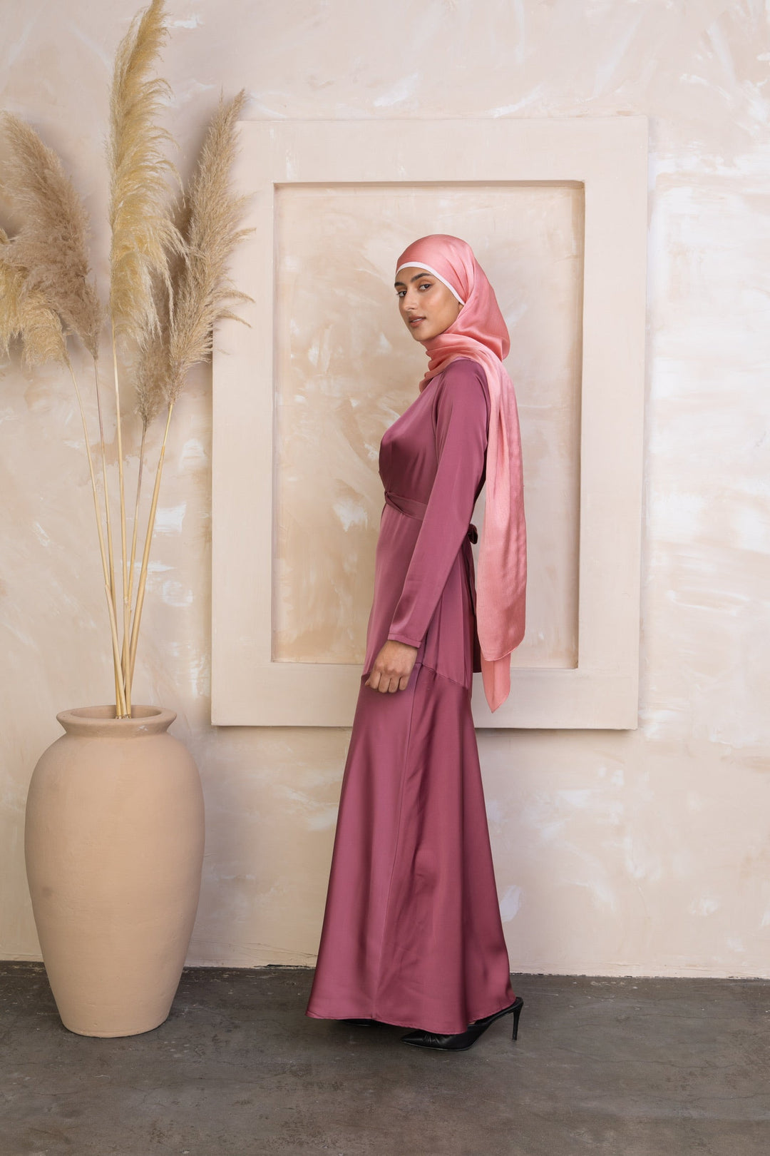 Woman in a mauve Desert Rose Criss Cross Satin Maxi Dress with pink hijab