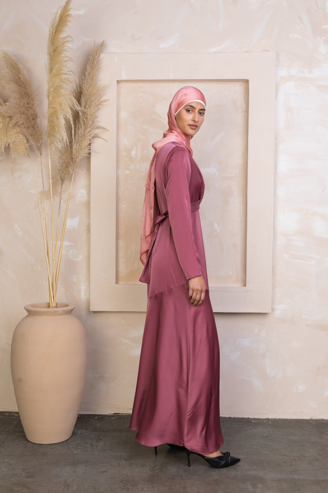 Woman in a mauve satin dress and hijab wearing the Desert Rose Criss Cross Satin Maxi Dress