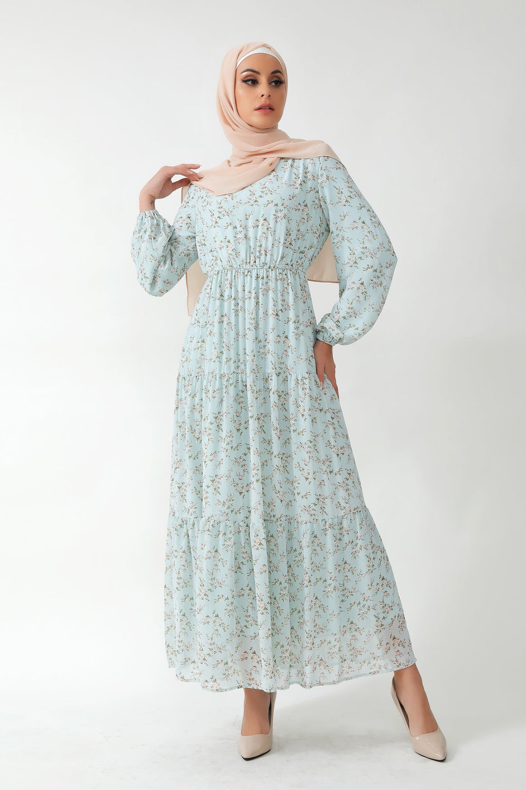 Woman in a floral tiered maxi dress featuring dreamy blue floral patterns