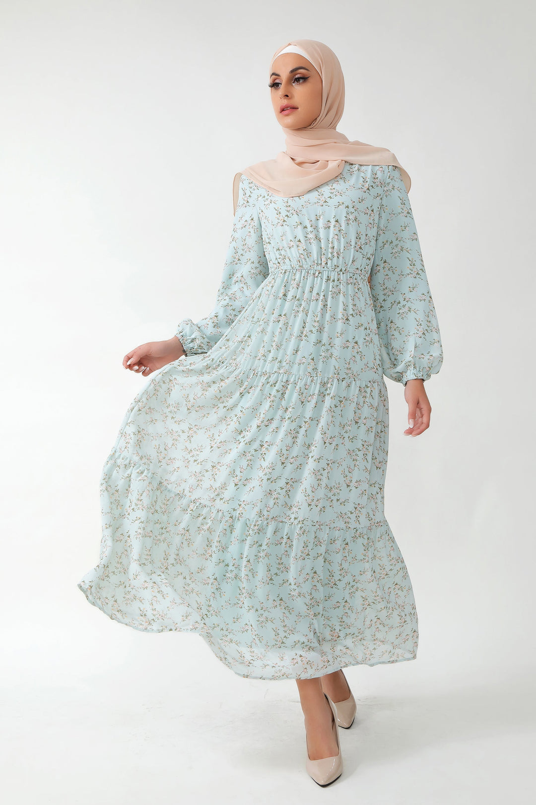 Woman in a Dreamy Blue Floral Tiered Maxi Dress with hijab, showcasing style and elegance