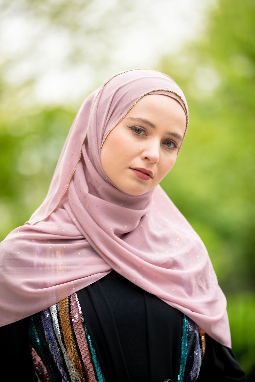 Woman in a pink hijab featuring beautiful beaded trim, showcasing Dusty Pink Beaded Chiffon Hijab