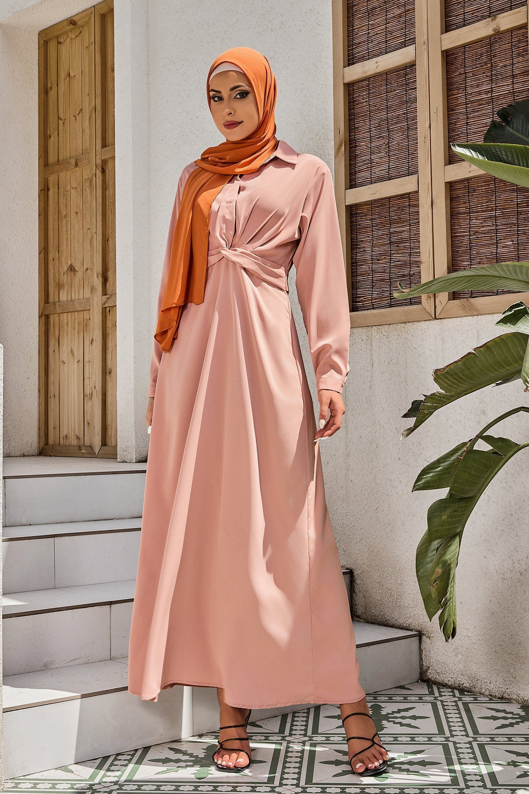 Woman in a dusty pink criss cross button down maxi dress with hijab