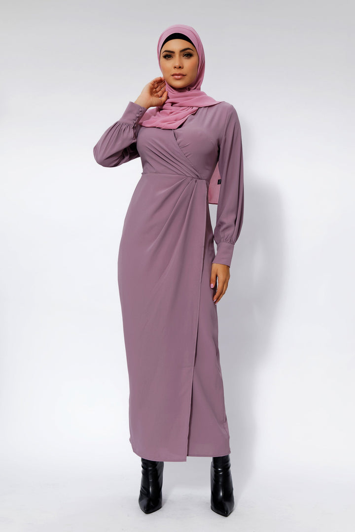 Woman modeling a Dusty Purple Wrap Maxi Dress with a criss cross neckline and pink hijab