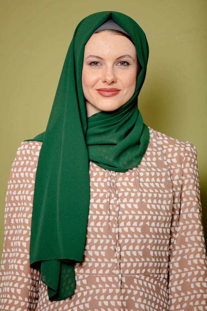 Woman in a green chiffon hijab showcasing the Evergreen Chiffon Hijab scarf