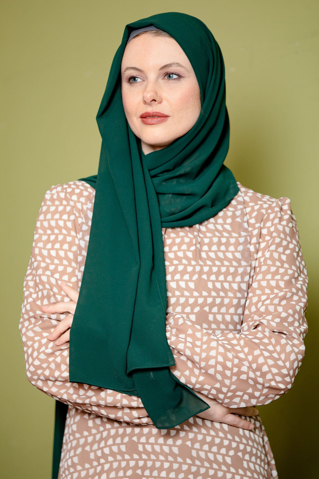 Woman in green hijab styled with a chiffon scarf, perfect for pairing with maxi dress