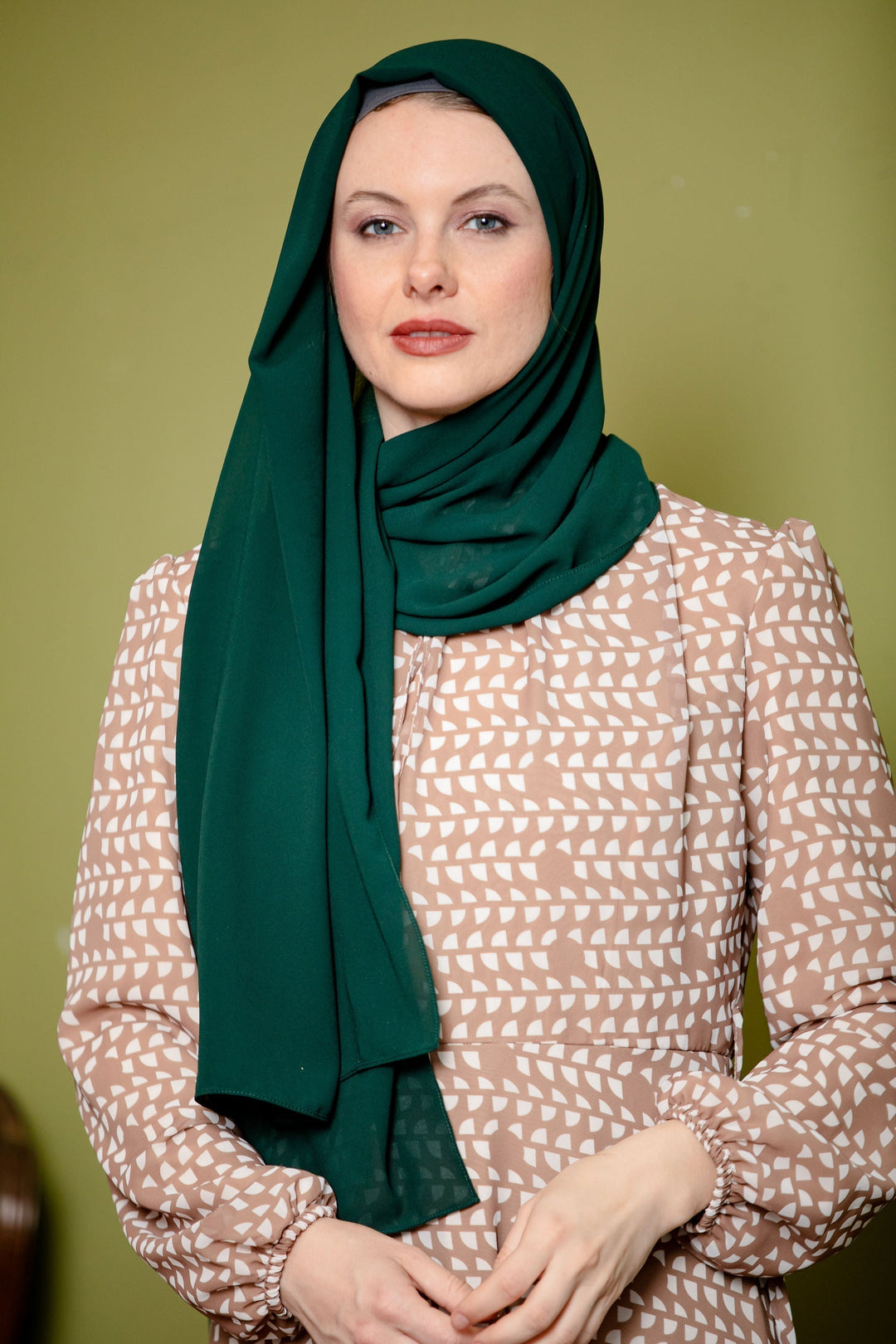 Woman in a green hijab styled with a chiffon scarf perfect for a maxi dress