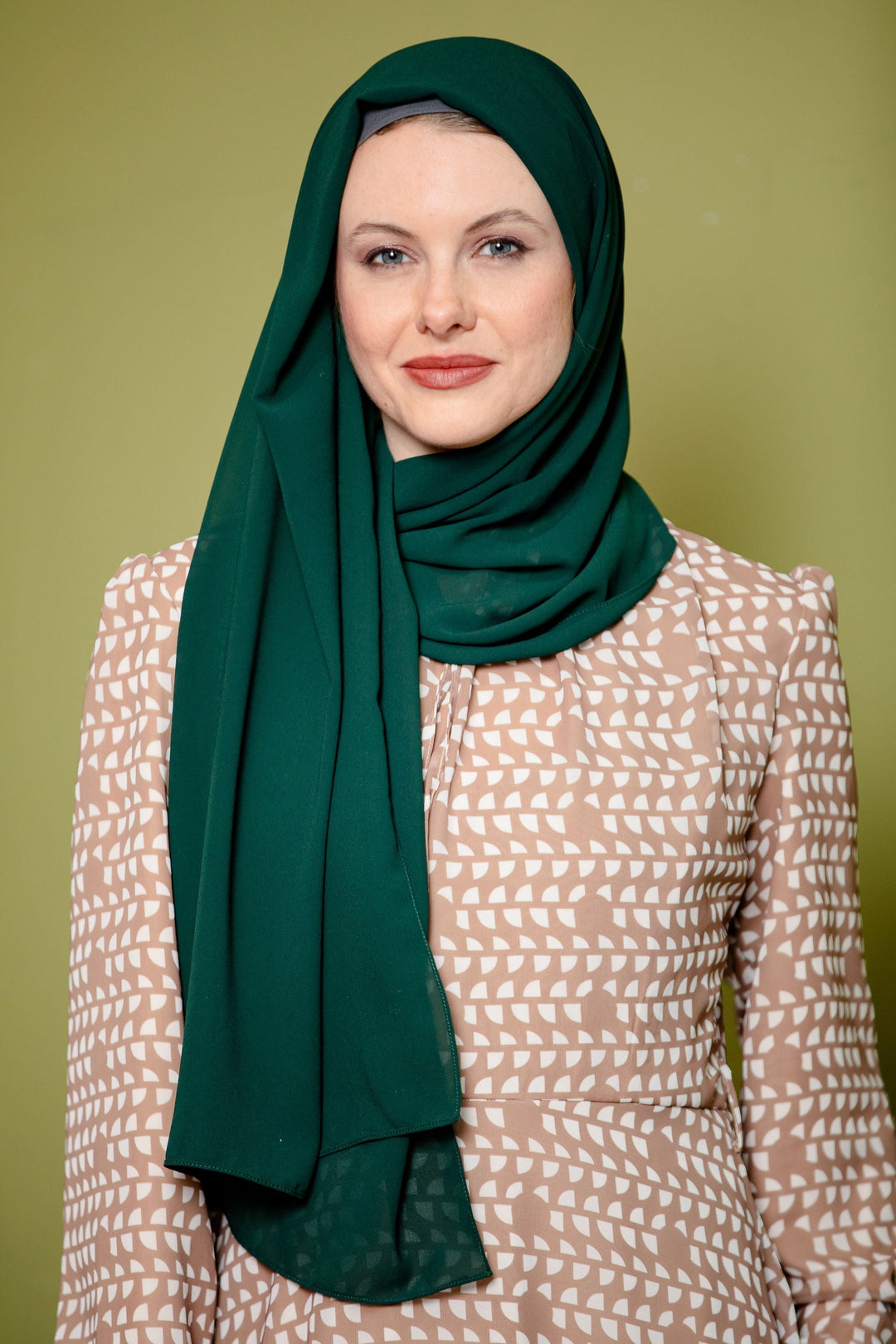 Woman in a Forest Green Chiffon Hijab styled with a maxi dress and elegant scarf