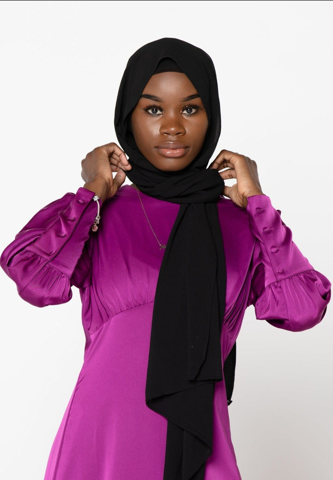 Woman in a purple dress and black hijab wearing a Fuschia Satin Long Sleeve Maxi Dress