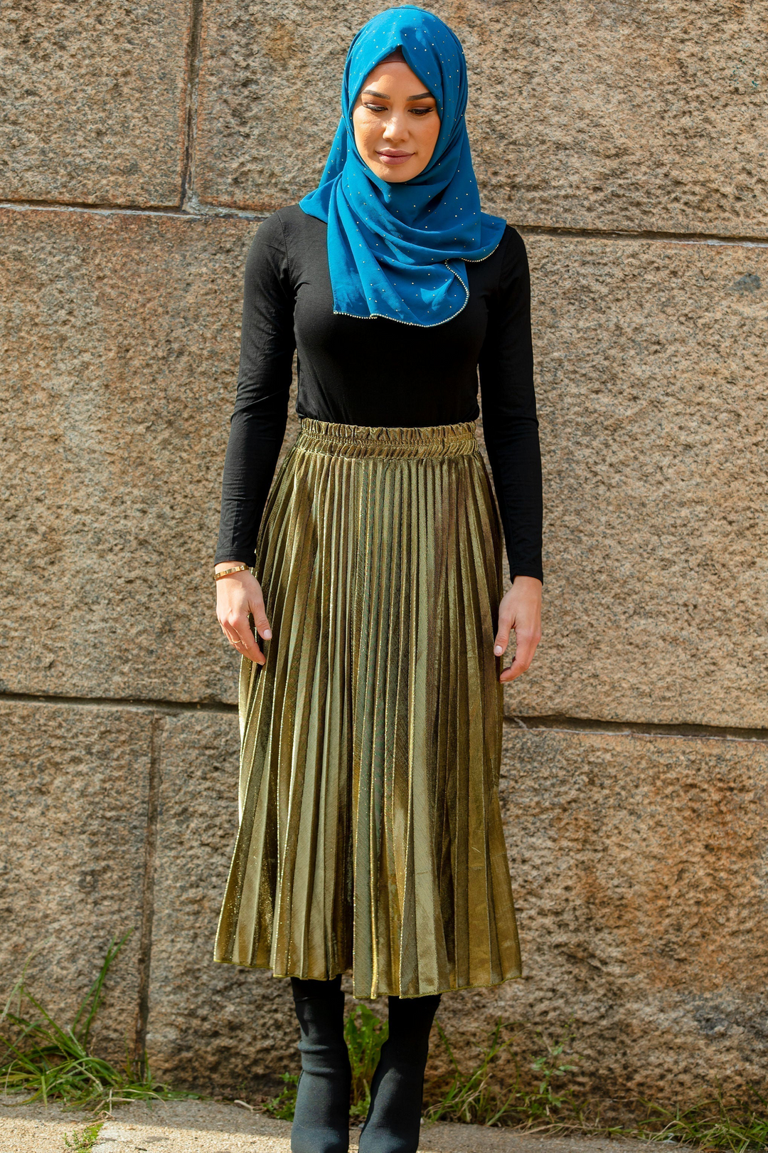 Woman in hijab wearing gold metallic pleated chiffon maxi skirt on clearance