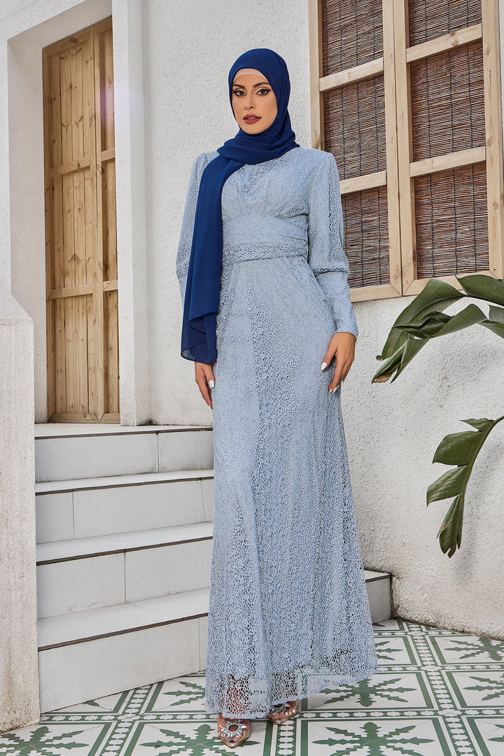 Woman in light blue lace dress with dark blue hijab modeling gray lace ruched gown