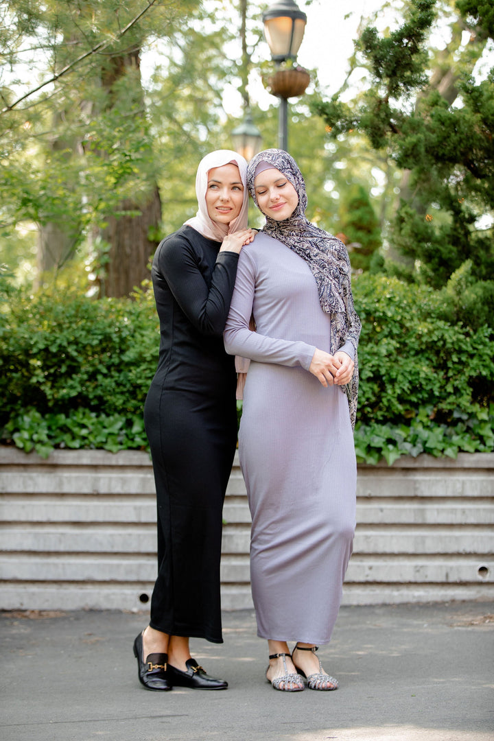 Two women in modest long sleeve maxi dresses showcasing a Gray Ribbed Jersey design