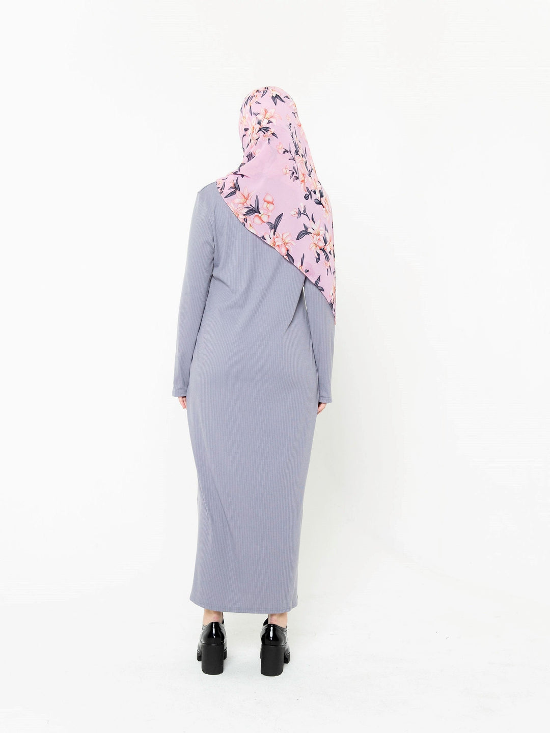 Woman in a long-sleeved gray dress and floral hijab showcasing a long sleeve maxi dress