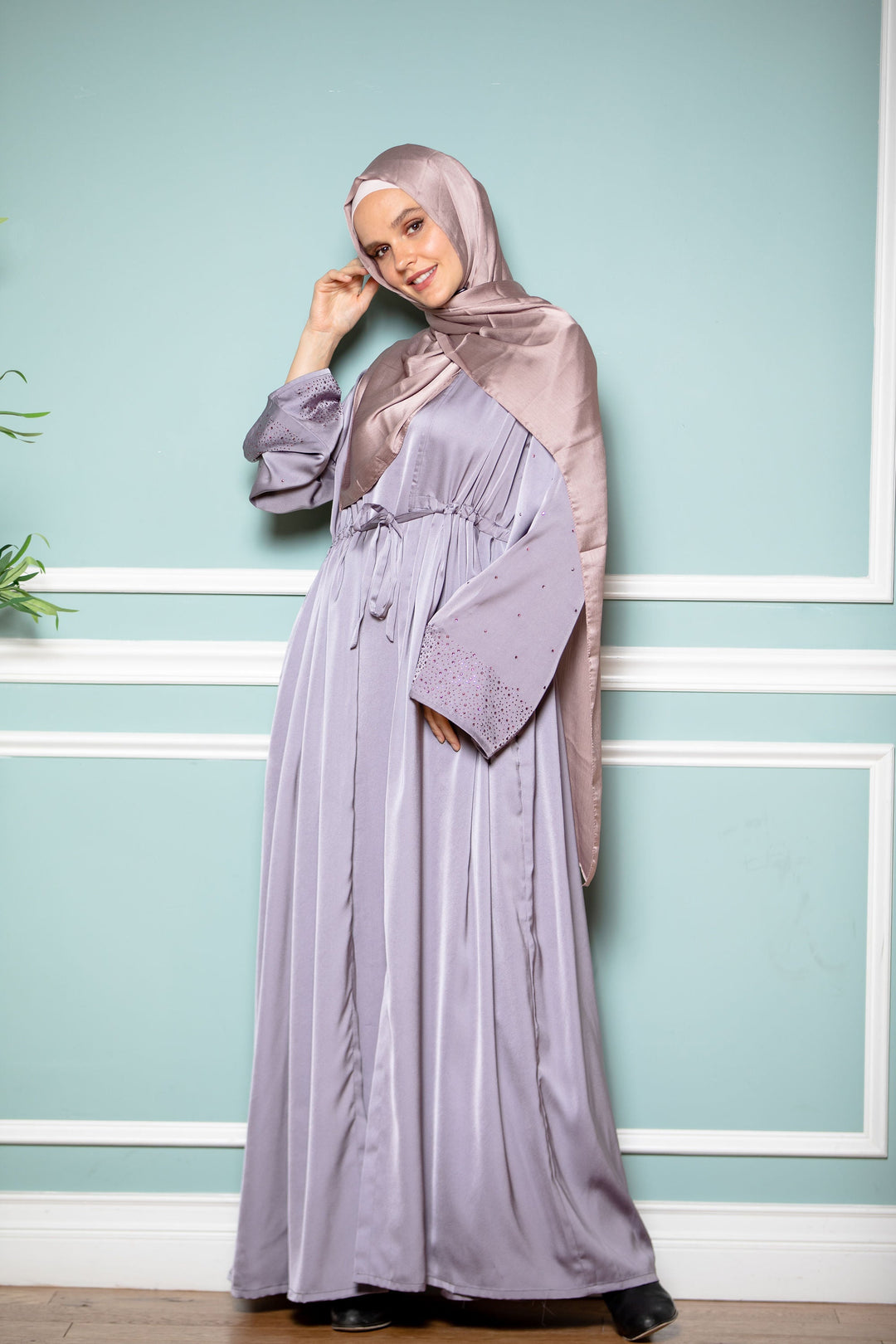 Woman in a long, shiny lilac satin maxi dress and hijab showcasing Gray Satin Drawstring Abaya