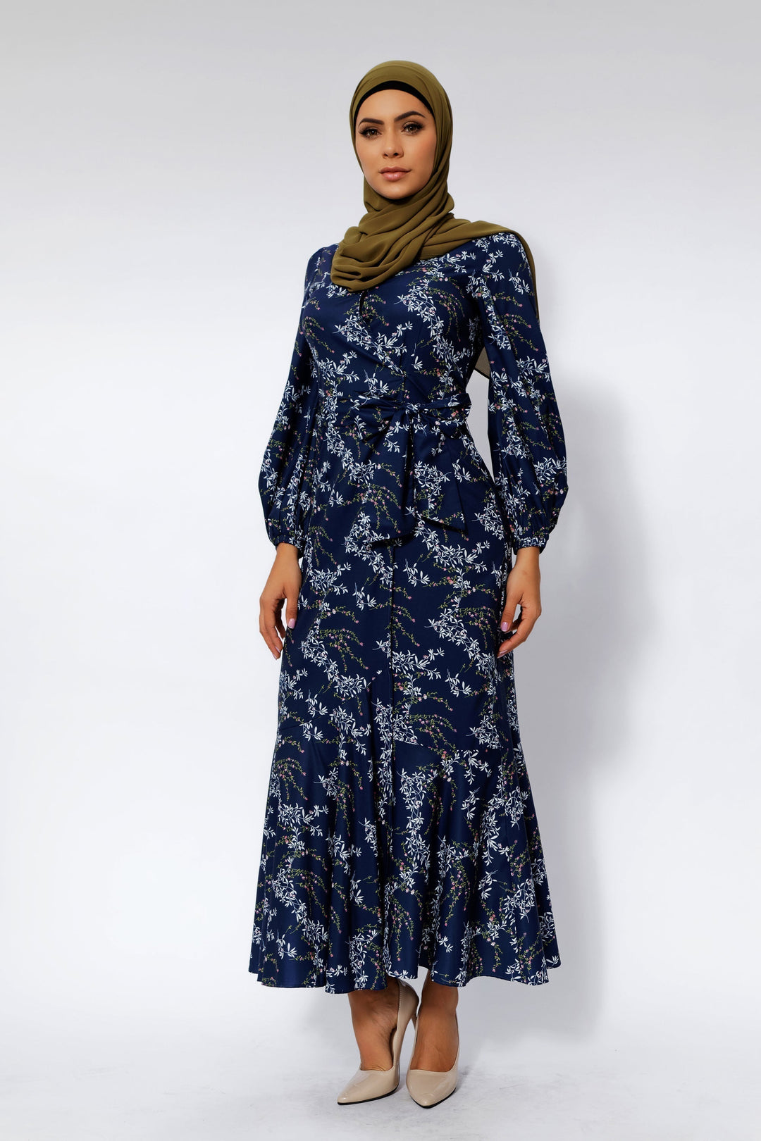 Woman in a floral ruffle faux wrap dress featuring heavenly blue floral design