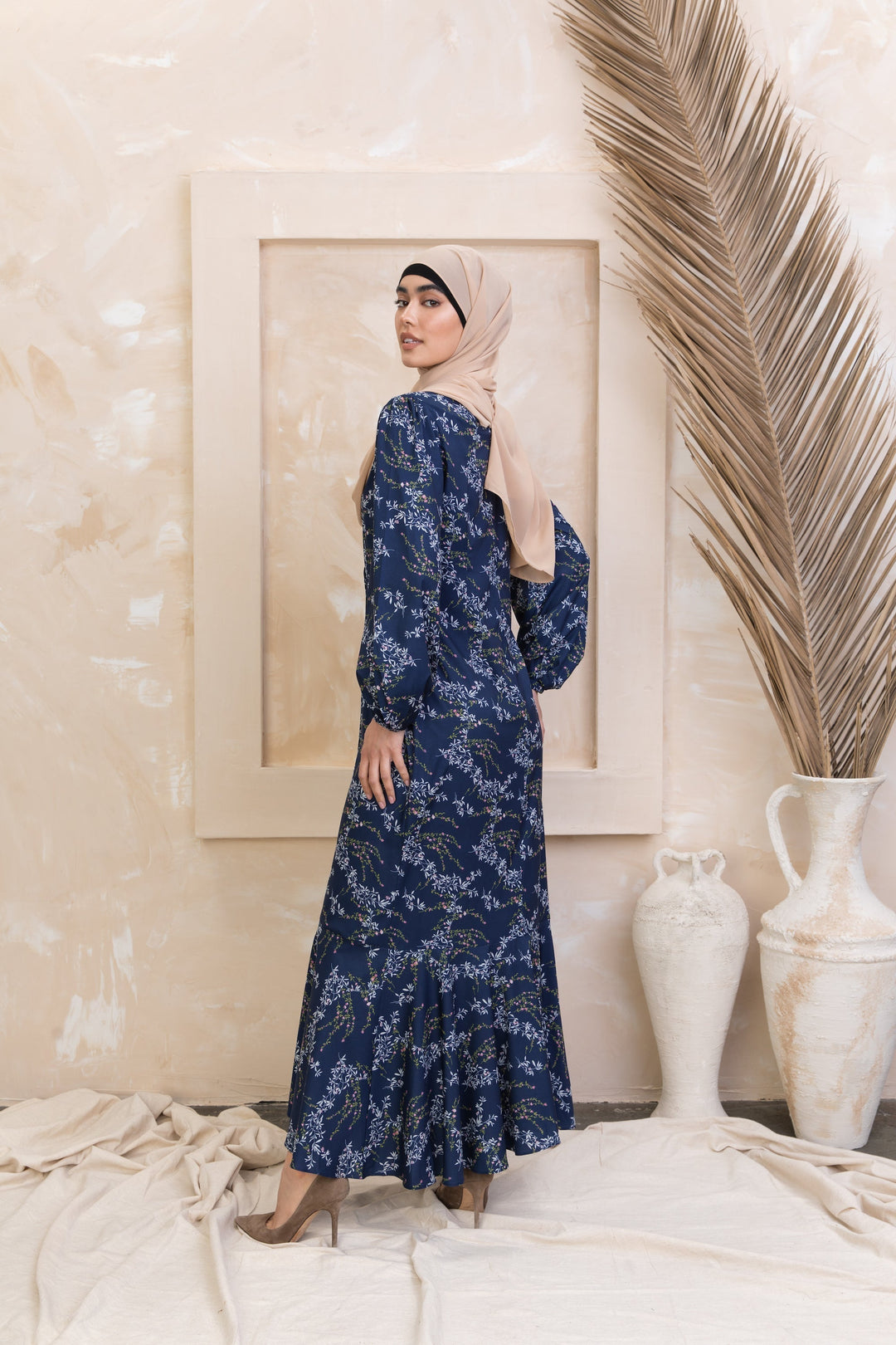 Woman in a long-sleeved hijab presenting Heavenly Blue Floral Ruffle Faux Wrap Maxi Dress