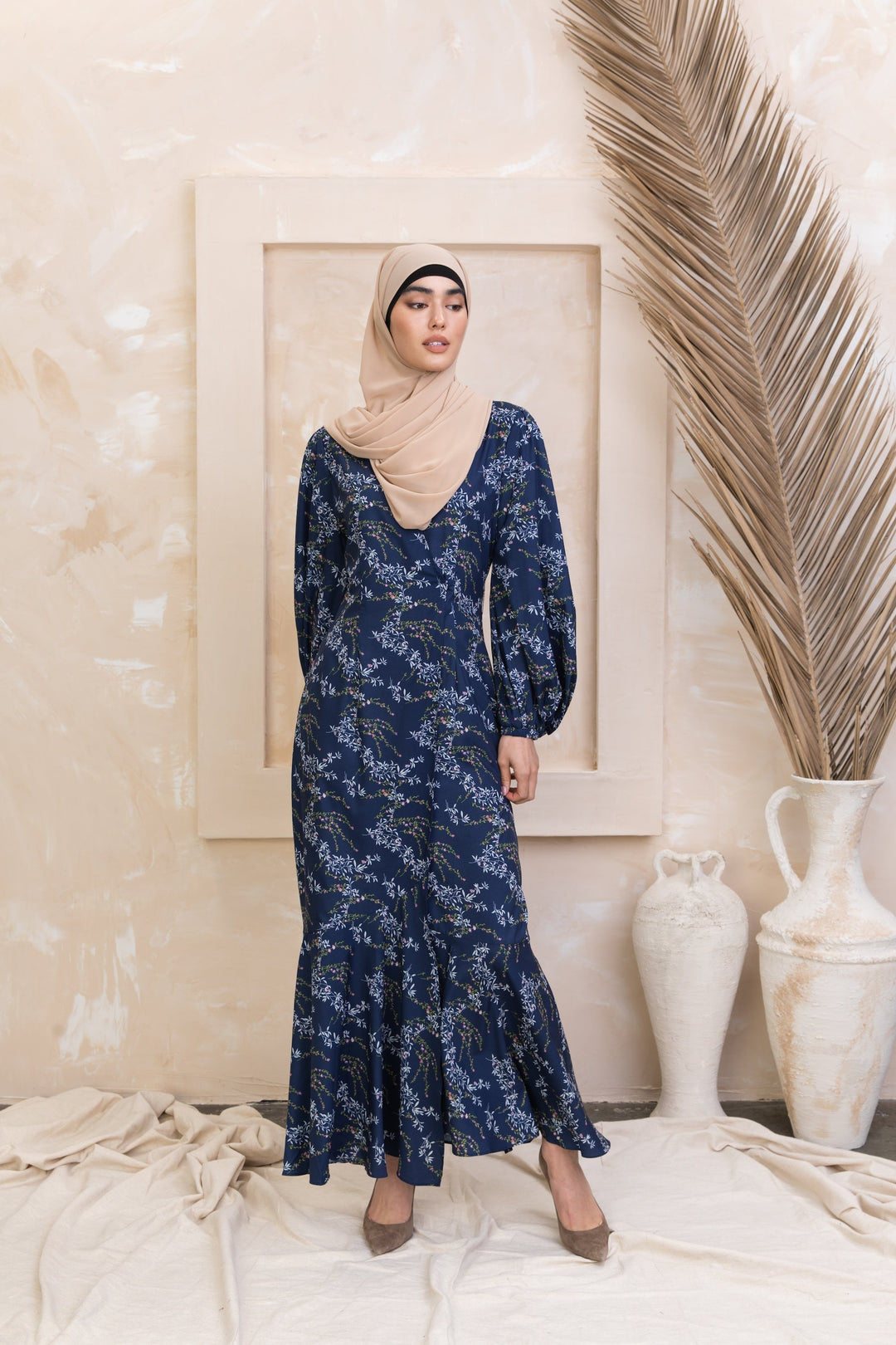 Woman in a long-sleeved hijab wearing a Heavenly Blue Floral Ruffle Faux Wrap Maxi Dress