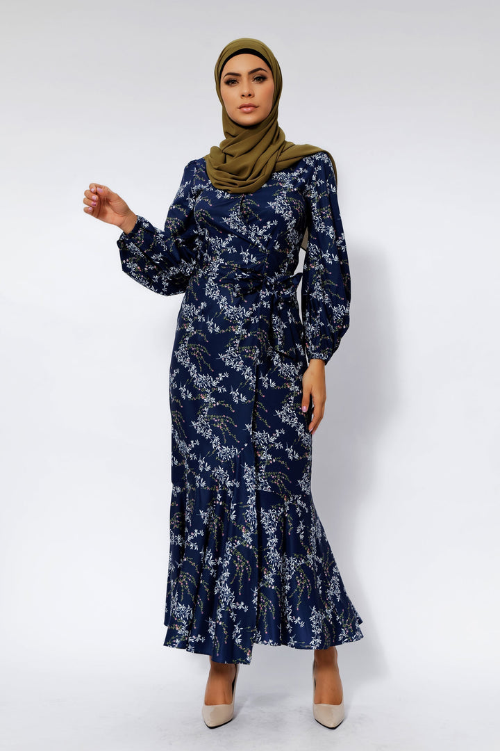 Woman in a Heavenly Blue Floral Ruffle Faux Wrap Maxi Dress with a stylish hijab