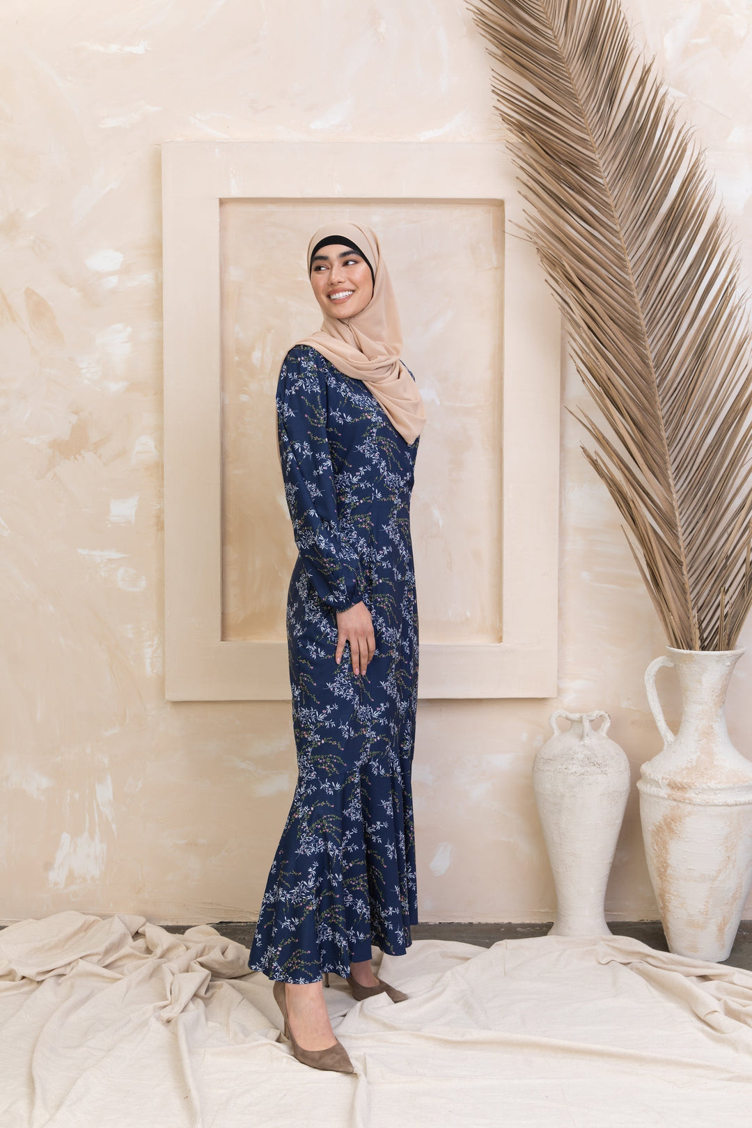 Woman in a floral dress and hijab wearing Heavenly Blue Floral Ruffle Faux Wrap Maxi Dress