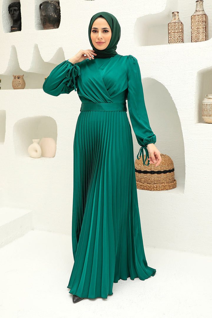 Emerald green criss cross pleated satin gown with long sleeves and maxi length design