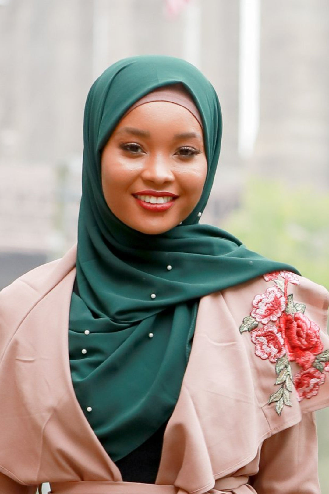 Woman wearing Hunter Green Pearl Chiffon Hijab with floral-embroidered jacket