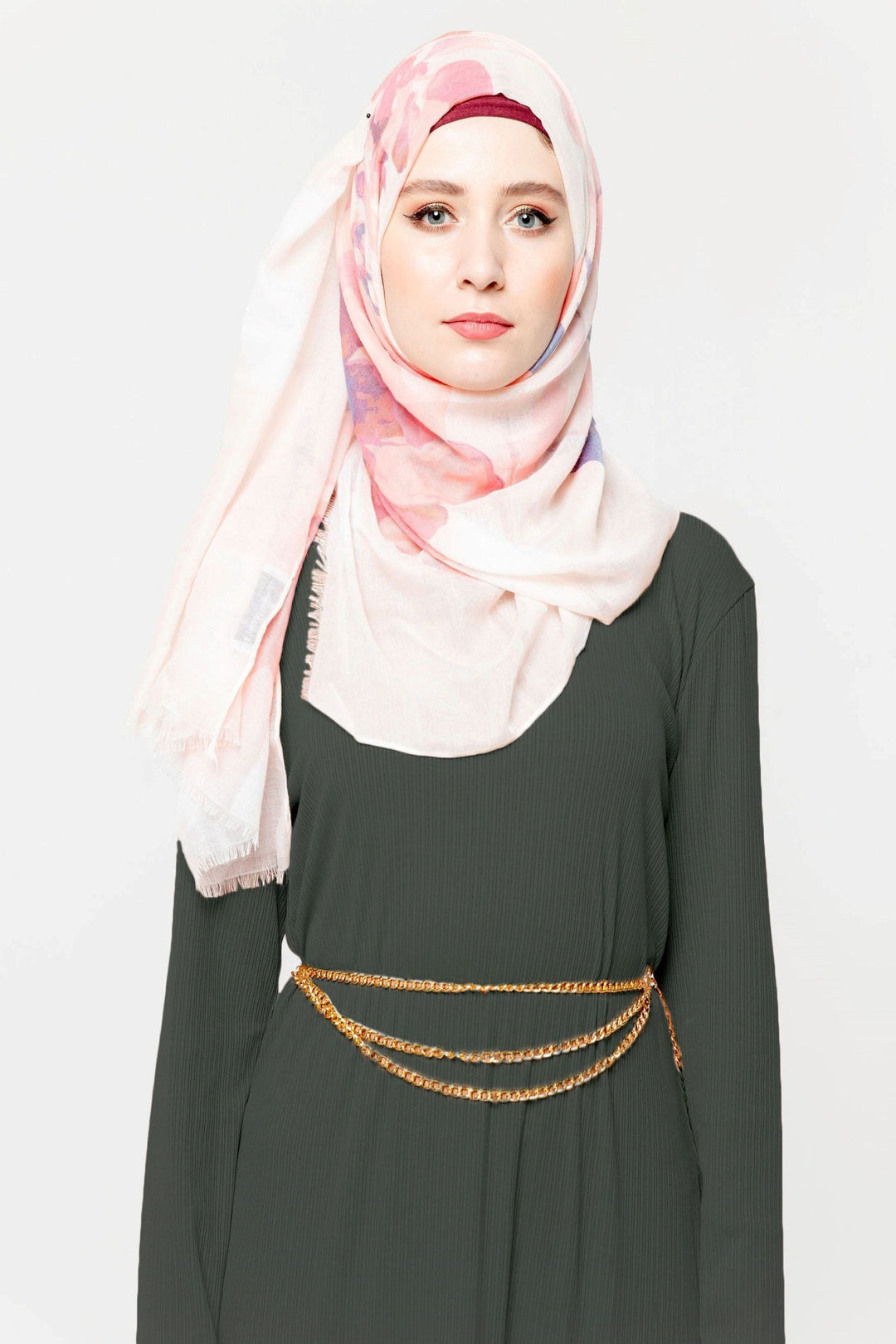 Woman in hijab wearing a Hunter Green Ribbed Long Sleeve Maxi Dress with gold chain belt