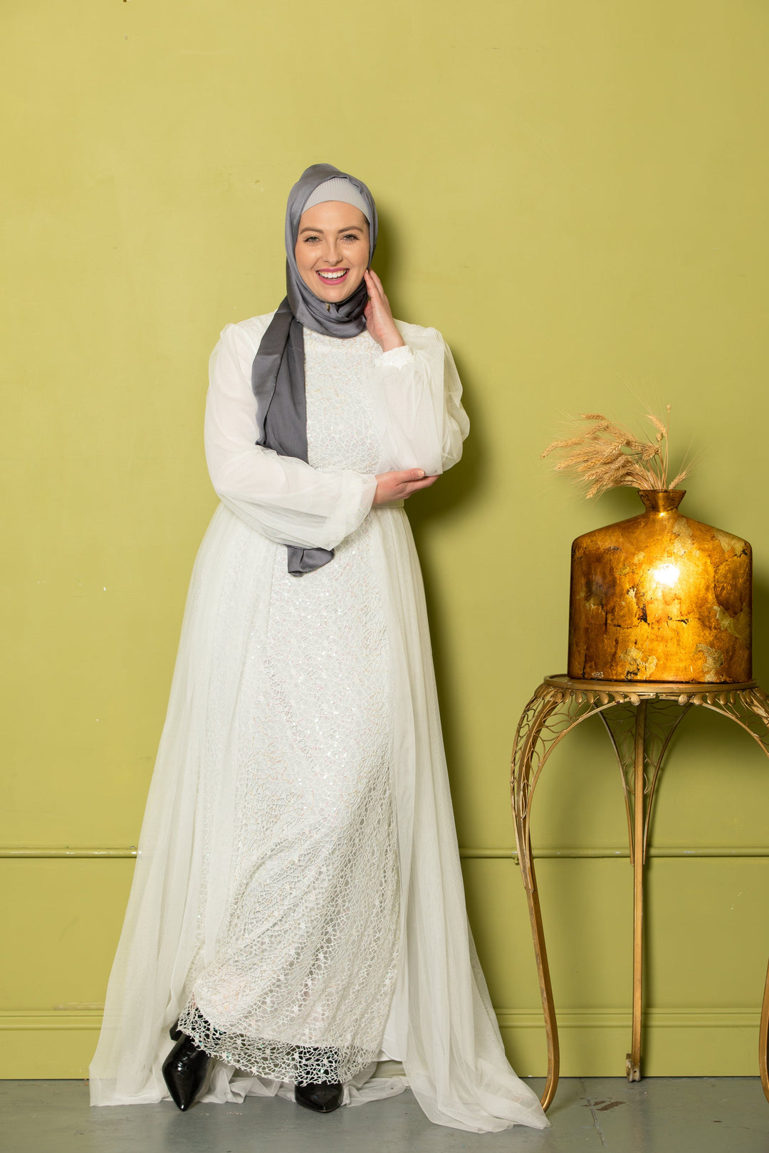 Woman in white sequined dress and gray hijab showcasing Ivory Lace with Chiffon Overlay Gown