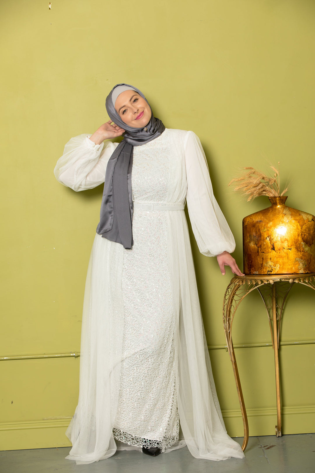 Woman in white dress and gray hijab wearing an Ivory Lace with Chiffon Overlay Gown