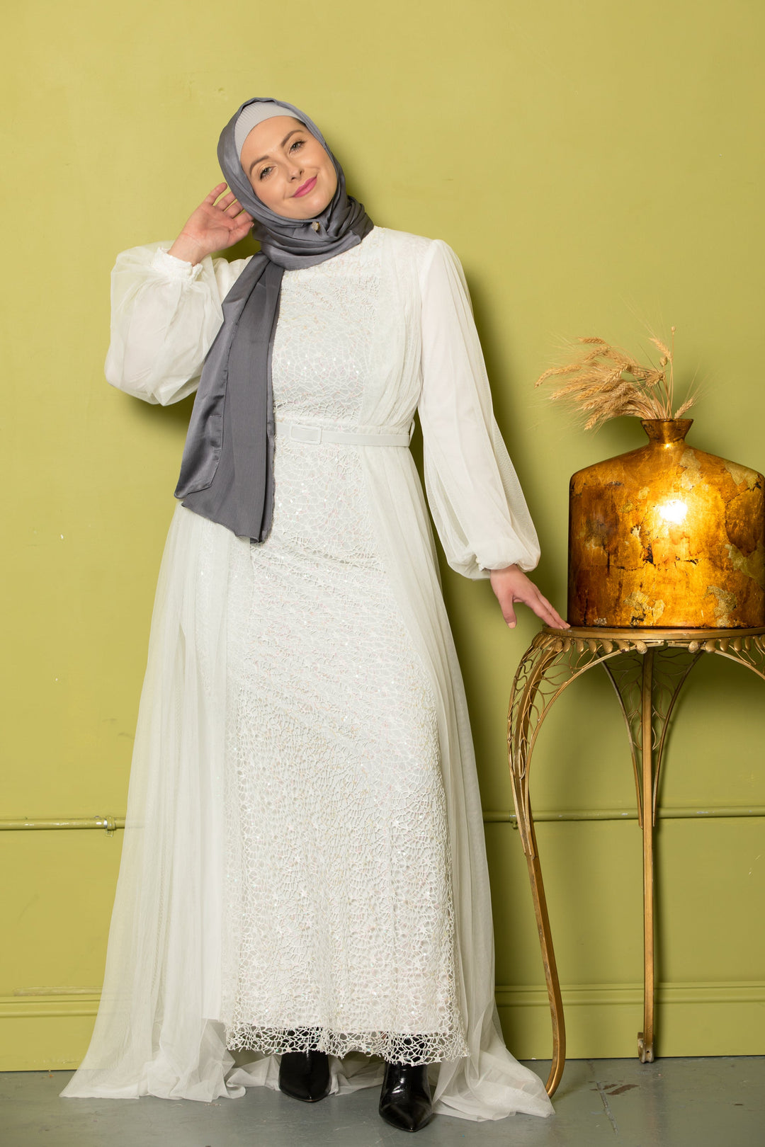 Woman in a white dress with gray hijab wearing Ivory Lace with Chiffon Overlay Gown